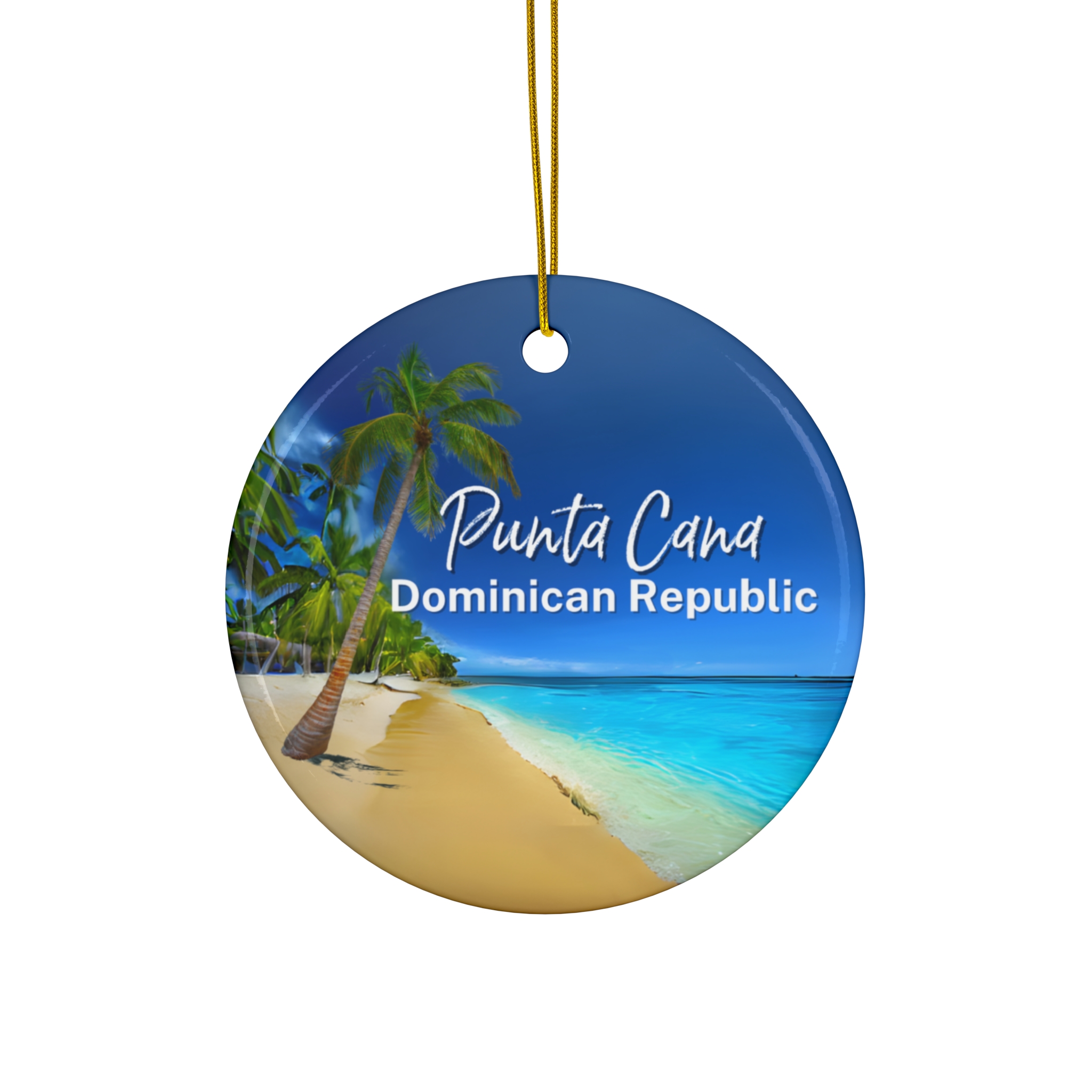 Round ornament featuring a tropical beach scene with palm trees, golden sand, and clear blue water. “Punta Cana Dominican Republic” is displayed on the front. A gold string is attached for hanging this charming keepsake.