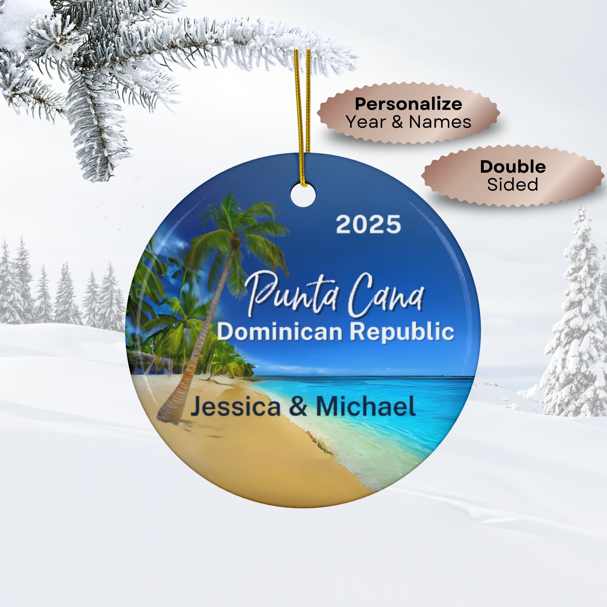 Round double-sided Punta Cana ornament with a beach scene labeled “Punta Cana, Dominican Republic 2025.” Personal names “Jessica & Michael” are shown. Text bubbles indicate personalization options. Snowy background with pine branches is visible.