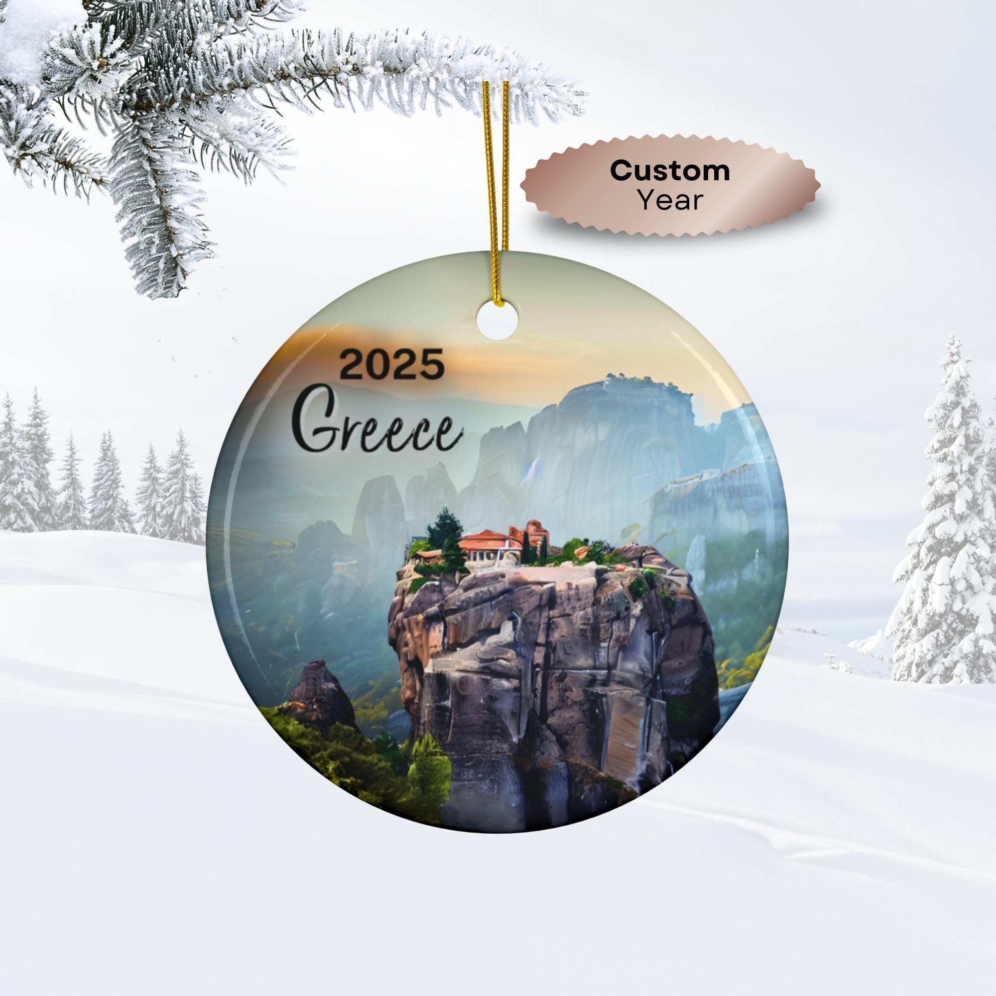 Round double-sided ornament hanging from a gold string, featuring an image of a monastery atop Meteora’s cliffs in Greece, with “2025 Greece” text and a snowy winter scene. A label says Custom Year for your personalized ornament.